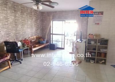 Cozy living room with tiled floor and stone accent wall