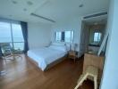 Bedroom with large windows and hardwood flooring