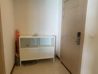 Hallway with white cabinet and shoes