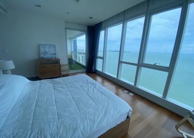 Bedroom with large windows and ocean view