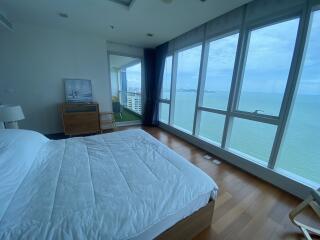 Bedroom with large windows and ocean view