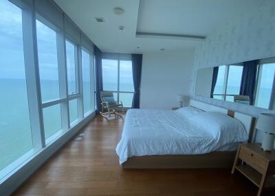 Spacious bedroom with large windows and ocean view