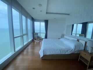 Spacious bedroom with large windows and ocean view