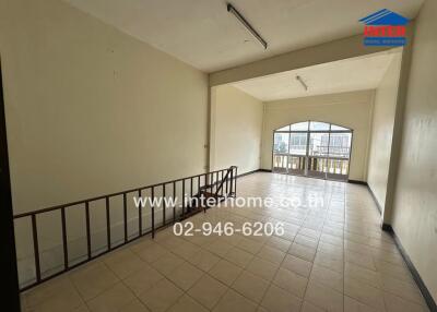 Main living area with tiled flooring and large window