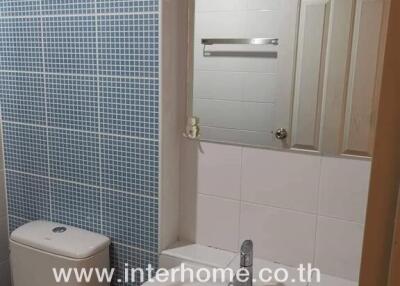 Modern bathroom with blue tiles and white fixtures