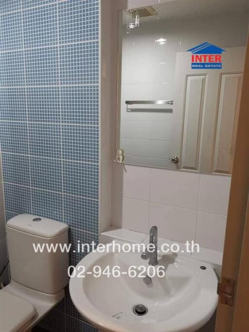 Modern bathroom with blue tiles and white fixtures