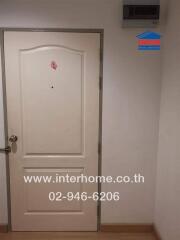 View of the front door with a sticker and interhome branding