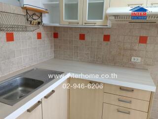 Modern kitchen with tiled backsplash and cabinetry