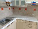 Modern kitchen with tiled backsplash and cabinetry