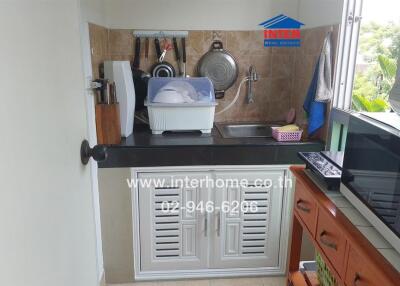 Compact kitchen with essential appliances and storage