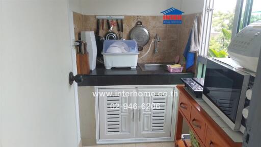 Compact kitchen with essential appliances and storage