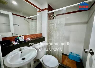 Modern bathroom with shower, sink, and toilet