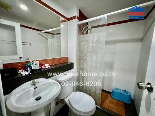 Modern bathroom with shower, sink, and toilet