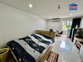 Modern bedroom with work desk and balcony