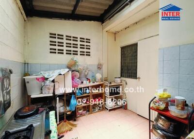 Small kitchen with appliances and shelves