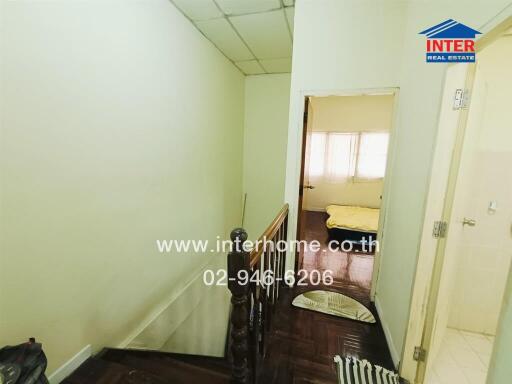 View of upstairs hallway with glimpse of bedroom