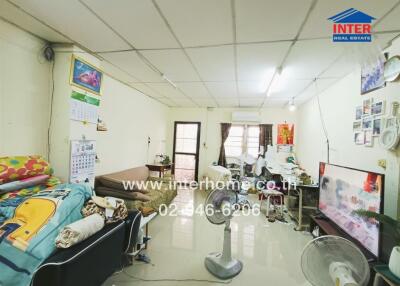 Living room with furniture, air conditioner, and television