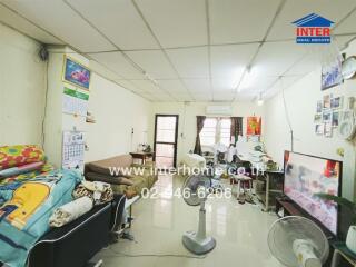 Living room with furniture, air conditioner, and television