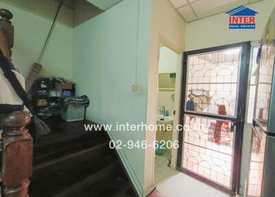 Main entryway with view of a staircase and laundry area