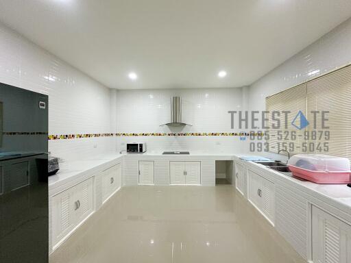 Modern kitchen with white cabinets and appliances