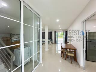 Modern open-plan living area with dining set and storage space