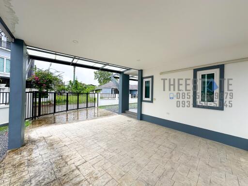 Covered garage area with view of driveway and gate