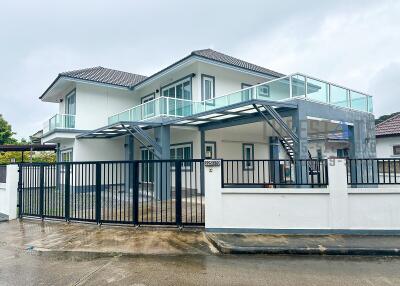 Modern two-story house with gated driveway