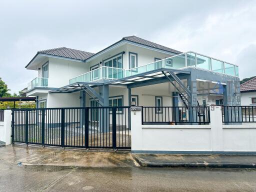 Modern two-story house with gated driveway