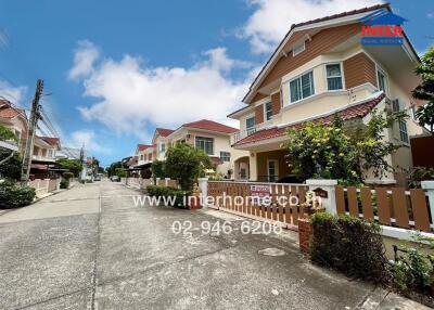 Exterior image of residential buildings with gardens and driveways