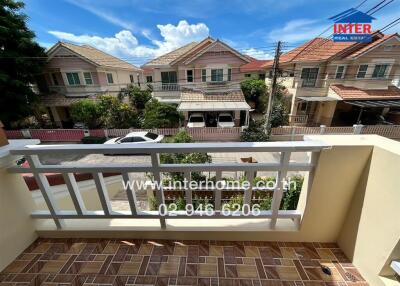 View of the balcony with neighborhood houses in the background