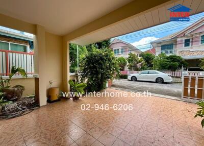 Covered porch area with view of driveway and neighborhood