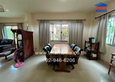 Dining room with a table, chairs, and large windows