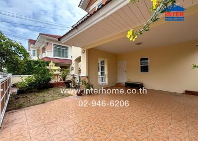 Front view of a house with a carport and garden