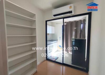 Room with shelves, sliding glass door, and air conditioner