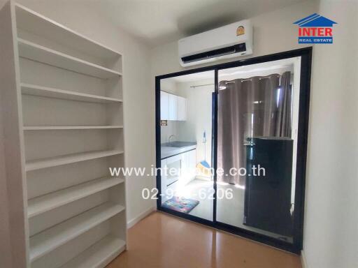 Room with shelves, sliding glass door, and air conditioner