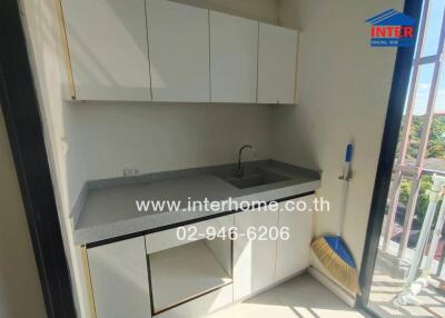 Modern white kitchen with balcony access