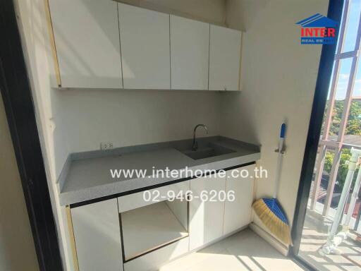 Modern white kitchen with balcony access