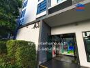 Entrance of a residential building with greenery and vending machines