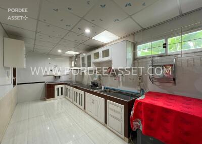 Modern kitchen with white cabinets and tiled floor