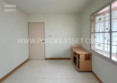 empty room with tiled floor and large window