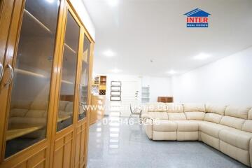 Spacious living room with a large sectional sofa and storage cabinets