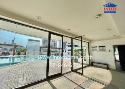 Indoor space with large windows overlooking the pool area