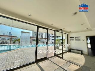 Indoor space with large windows overlooking the pool area