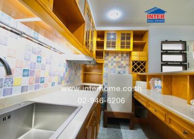 Modern kitchen with wooden cabinetry and colorful backsplash