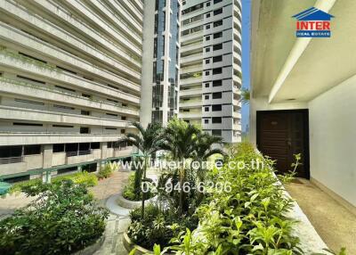 Exterior view of apartment buildings with greenery