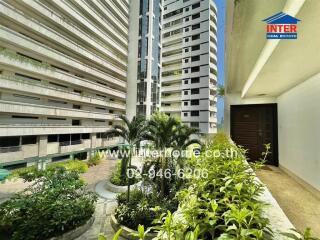 Exterior view of apartment buildings with greenery