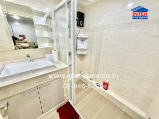 Modern bathroom with a sink, shower, and shelving