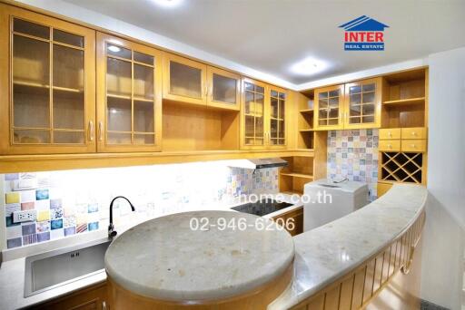 Modern kitchen with wooden cabinets and curved countertop