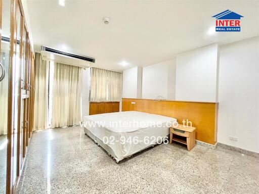 Spacious bedroom with large windows and ample natural light