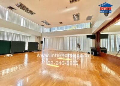 Spacious living room with large windows and hardwood floors